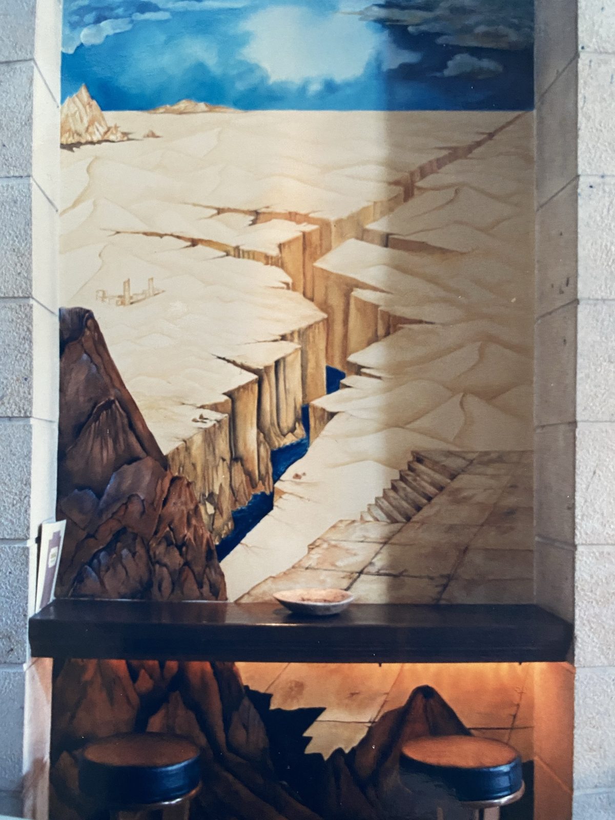 Wide mural with a stairs and cliff motif